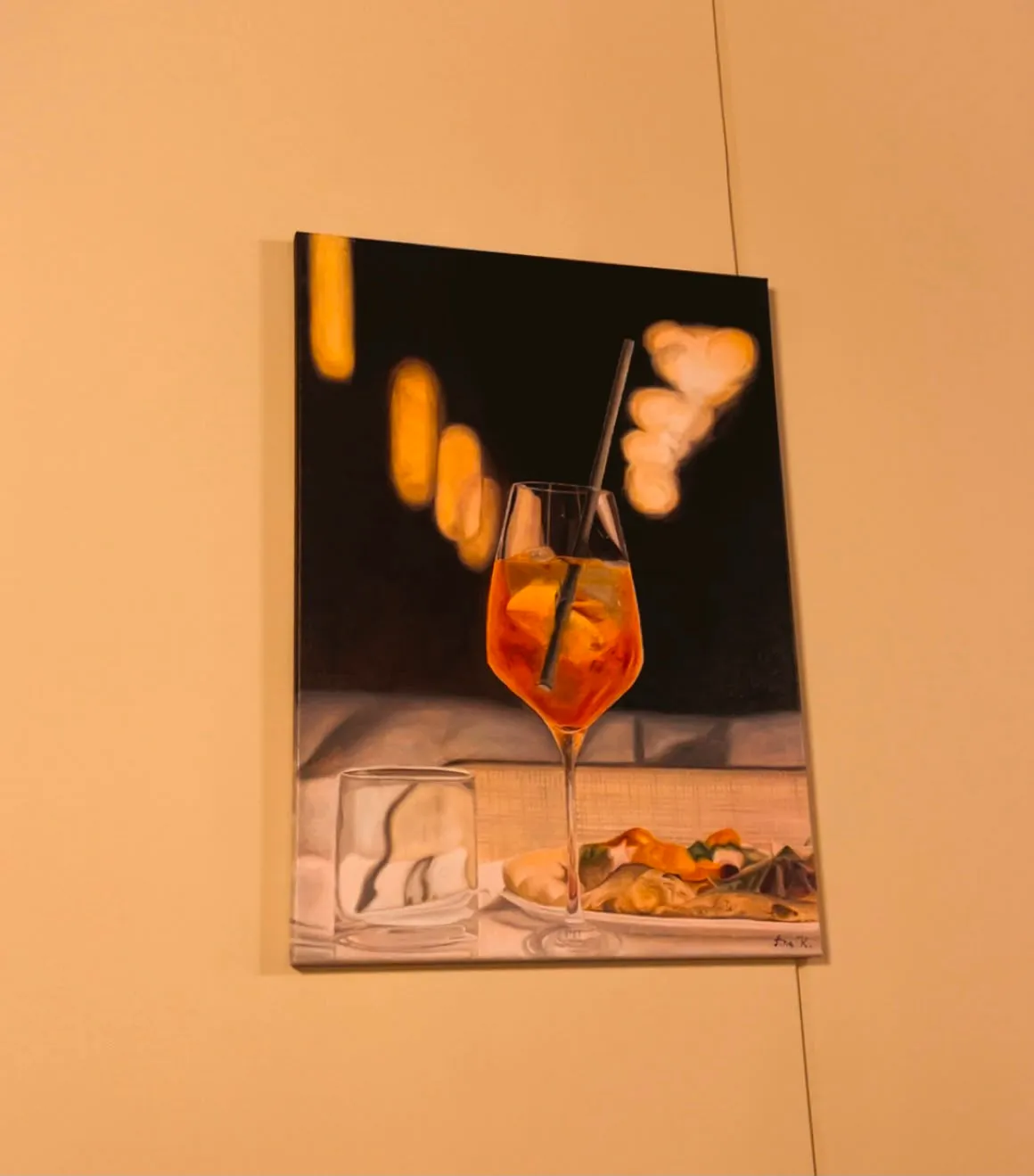 Realist oil painting of an Aperol spritz on a restaurant table at night, painted by Ana Kovač